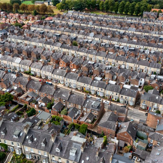 Aerial view of old terraced houses on back to back streets in the suburbs of a large UK city