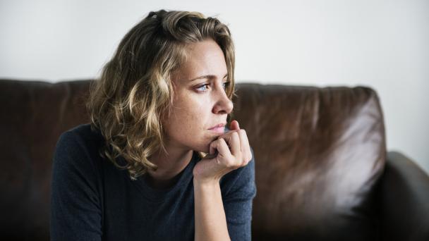Woman resting head in hands