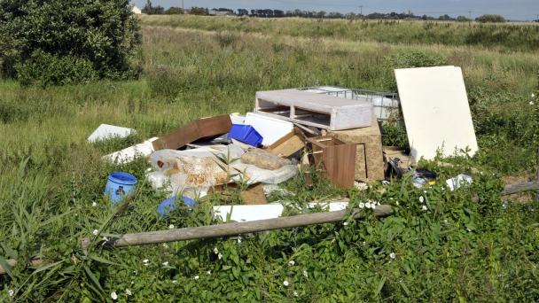 Abandoned rubbish in green field